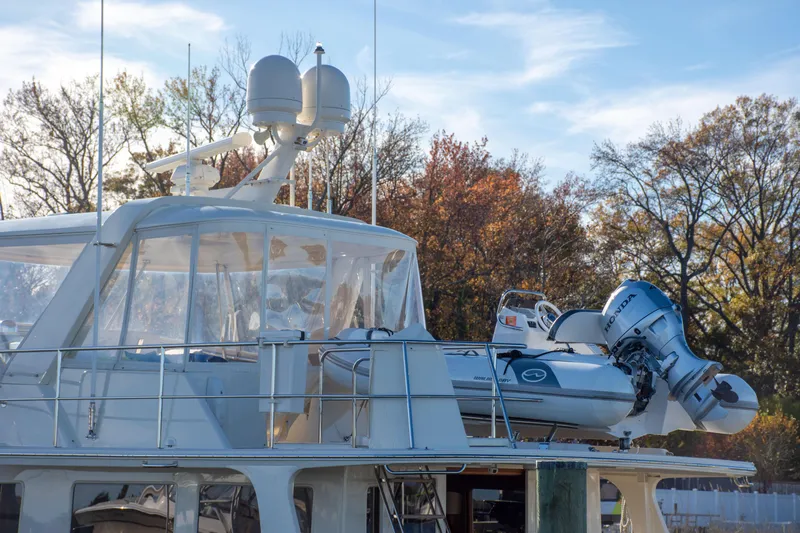  Yacht Photos Pics 2013 Fleming 55 yacht with dinghy on deck, surrounded by autumn trees.