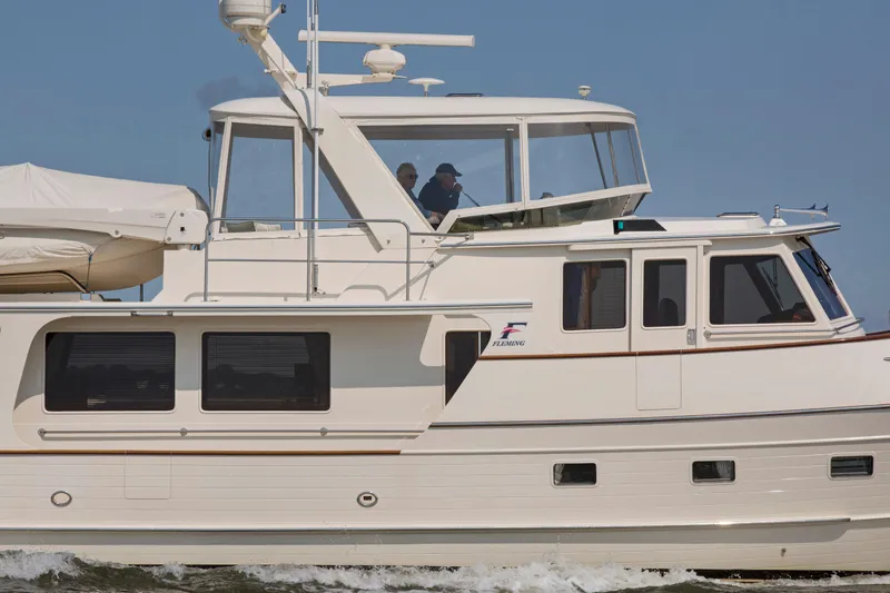  Yacht Photos Pics 2013 Fleming 55 yacht cruising on open water under clear skies.