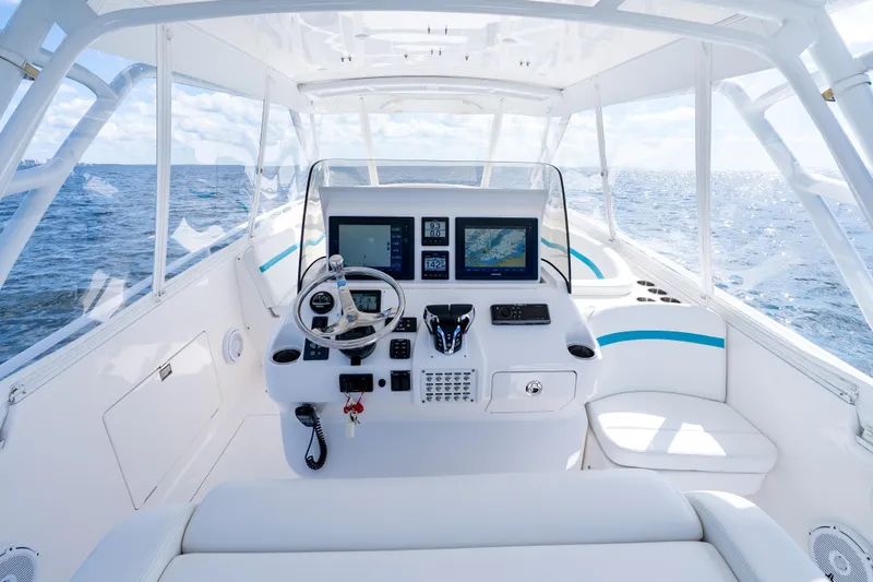  Yacht Photos Pics 2016 Intrepid 400 Cuddy helm with ocean view, featuring modern navigation equipment.