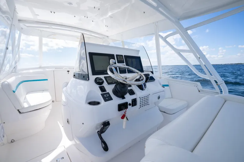 Yacht Photos Pics 2016 Intrepid 400 Cuddy boat interior with steering console and ocean view.