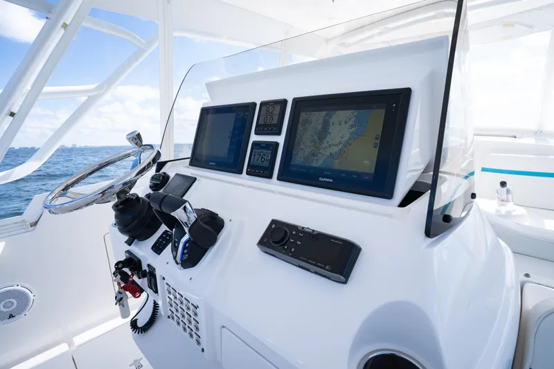  Yacht Photos Pics Intrepid 400 Cuddy 2016 helm with navigation screens and steering wheel, ocean view.