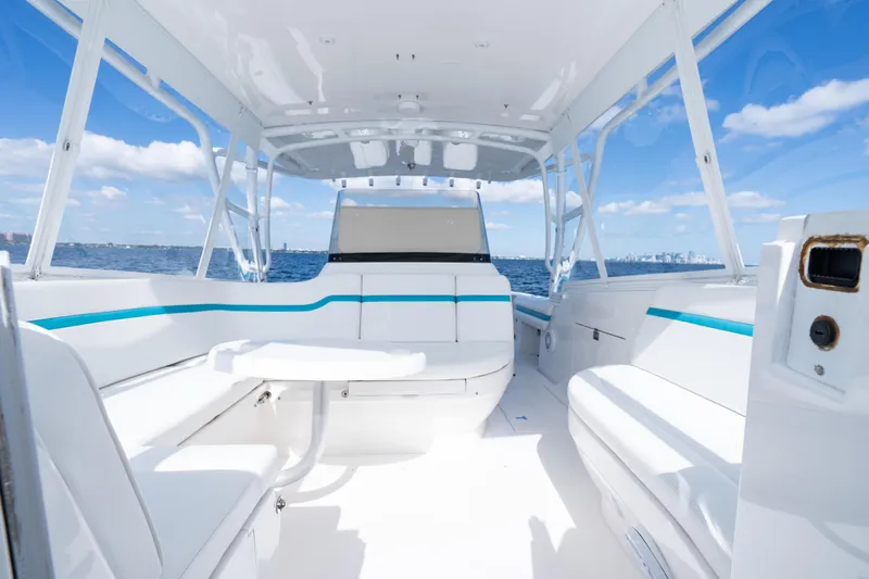  Yacht Photos Pics 2016 Intrepid 400 Cuddy boat interior with white seating, table, and ocean view.