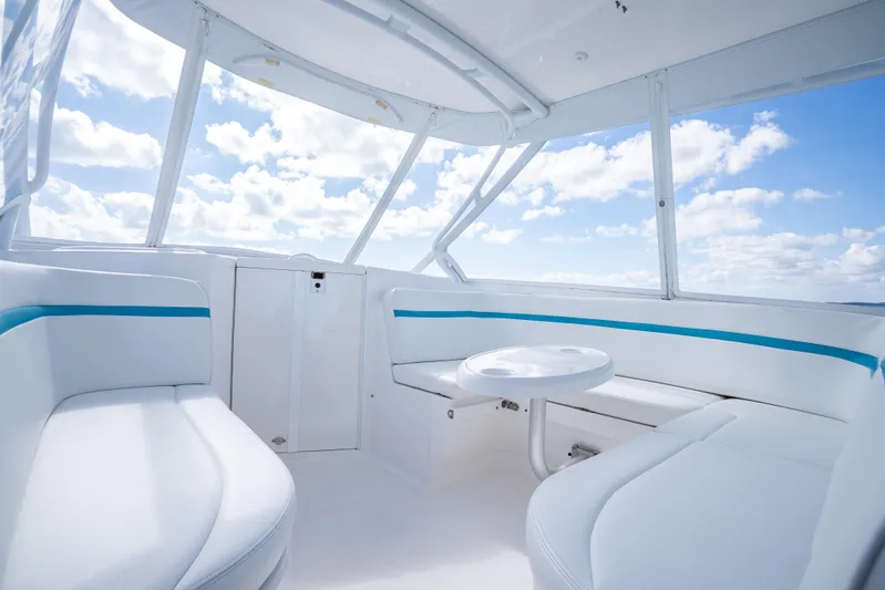  Yacht Photos Pics 2016 Intrepid 400 Cuddy interior with white seating and blue accents under a clear sky.