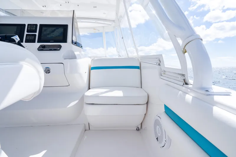  Yacht Photos Pics 2016 Intrepid 400 Cuddy interior with white seating and navigation equipment.