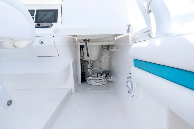  Yacht Photos Pics Interior view of a 2016 Intrepid 400 Cuddy boat, showcasing storage and control panels.