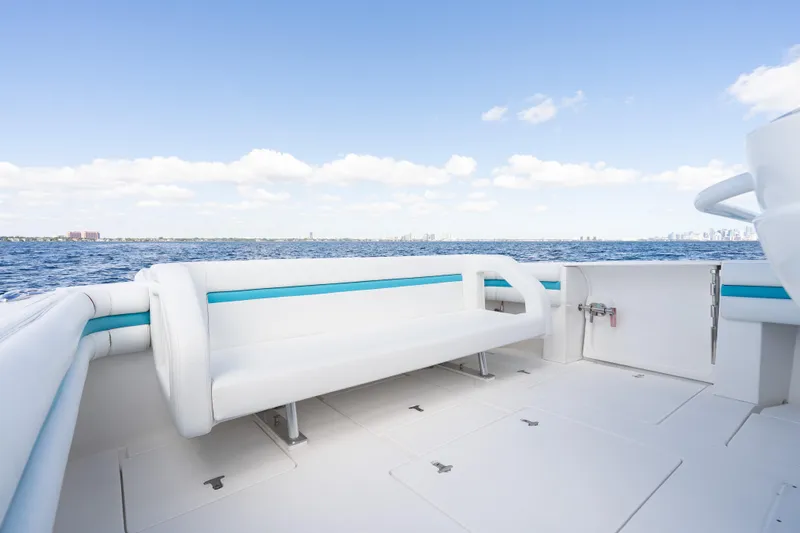  Yacht Photos Pics 2016 Intrepid 400 Cuddy boat interior with white seating, ocean view, and clear sky.