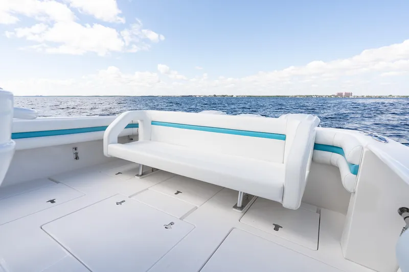  Yacht Photos Pics 2016 Intrepid 400 Cuddy boat interior with white seating, ocean view, and blue accents.