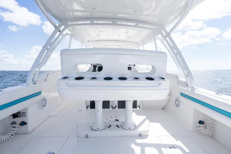  Yacht Photos Pics 2016 Intrepid 400 Cuddy boat interior with rod holders, ocean view, and clear skies.