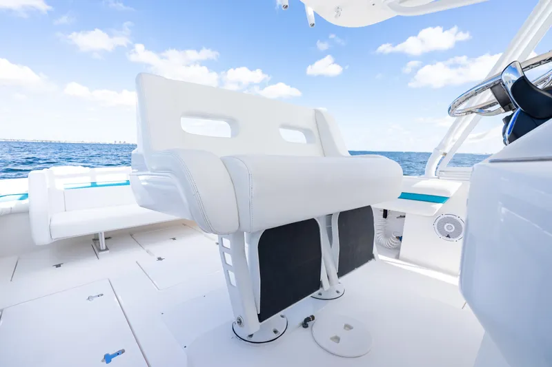  Yacht Photos Pics 2016 Intrepid 400 Cuddy boat interior with white seating and ocean view.