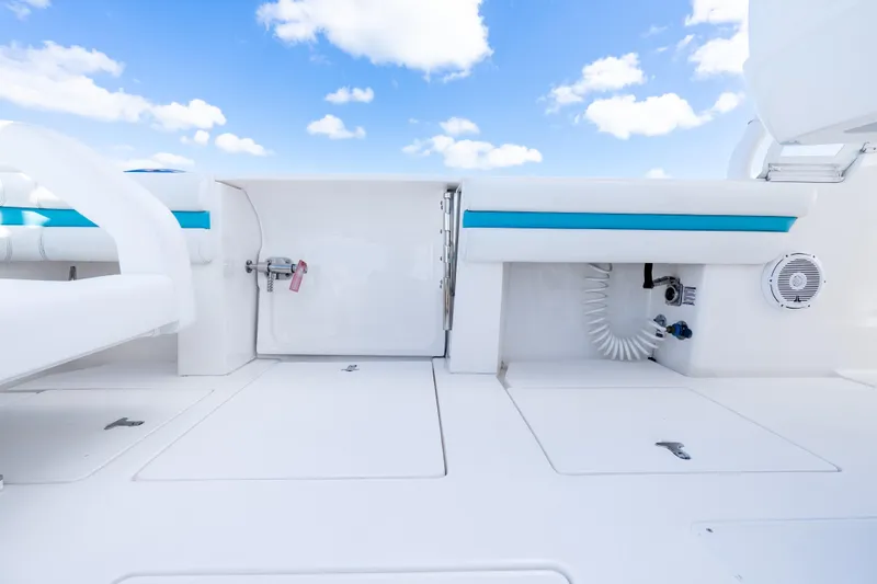  Yacht Photos Pics 2016 Intrepid 400 Cuddy boat interior with white seating and blue accents under a clear sky.