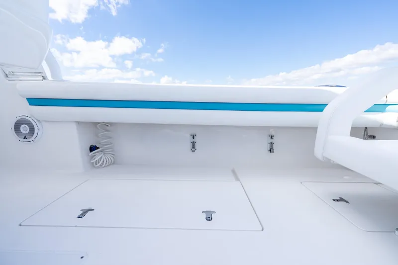  Yacht Photos Pics 2016 Intrepid 400 Cuddy boat deck with storage compartments and seating under blue sky.