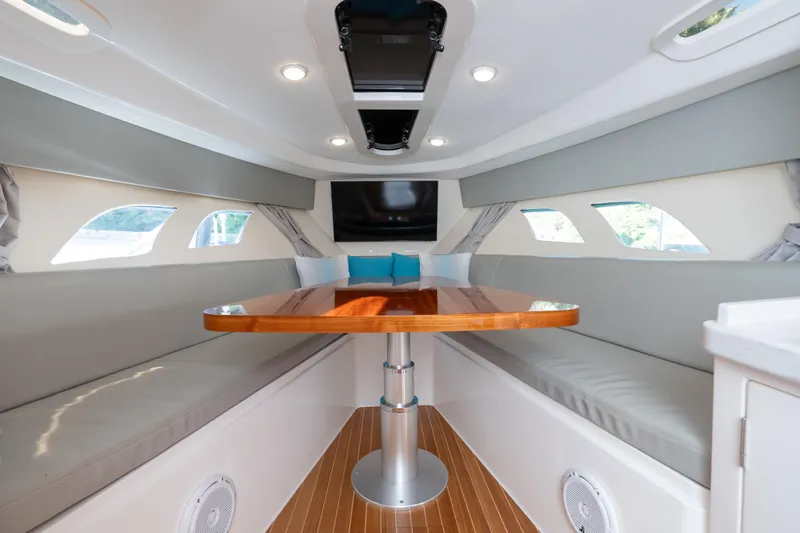  Yacht Photos Pics Luxurious interior of 2016 Intrepid 400 Cuddy boat with elegant seating and wooden table.