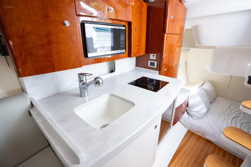  Yacht Photos Pics Luxurious 2016 Intrepid 400 Cuddy interior with modern kitchen and cozy sleeping area.