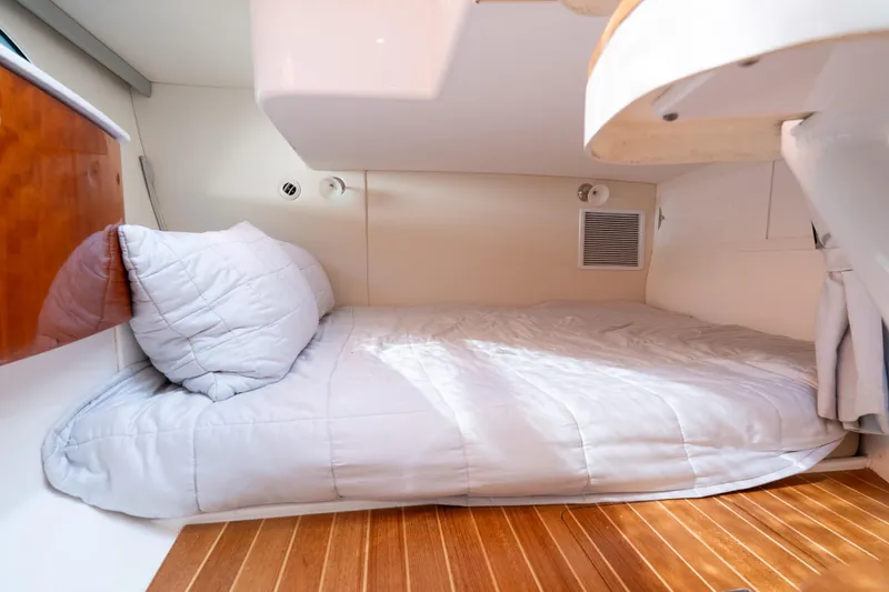  Yacht Photos Pics 2016 Intrepid 400 Cuddy cabin with cozy bed and wooden flooring.