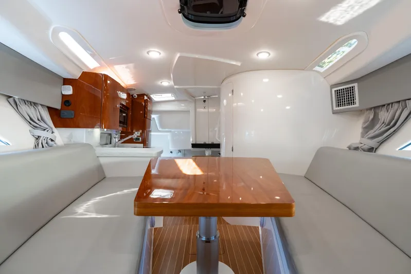  Yacht Photos Pics Luxurious interior of 2016 Intrepid 400 Cuddy boat with elegant seating and wooden table.