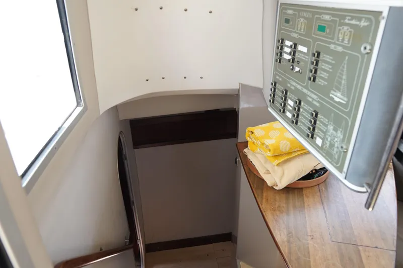 Loki Yacht Photos Pics Interior of 1995 Fountaine Pajot Venezia 42 yacht with control panel and folded linens.