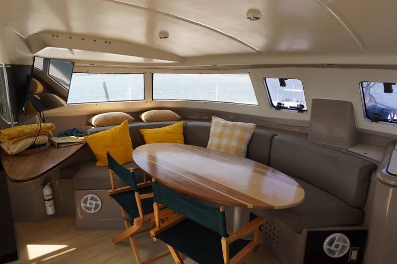 Loki Yacht Photos Pics Interior of 1995 Fountaine Pajot Venezia 42 catamaran with cozy seating and ocean view.