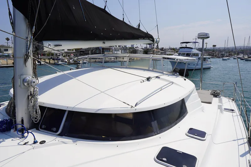 Loki Yacht Photos Pics Fountaine Pajot Venezia 42 catamaran, 1995 model, docked in a marina with clear skies.