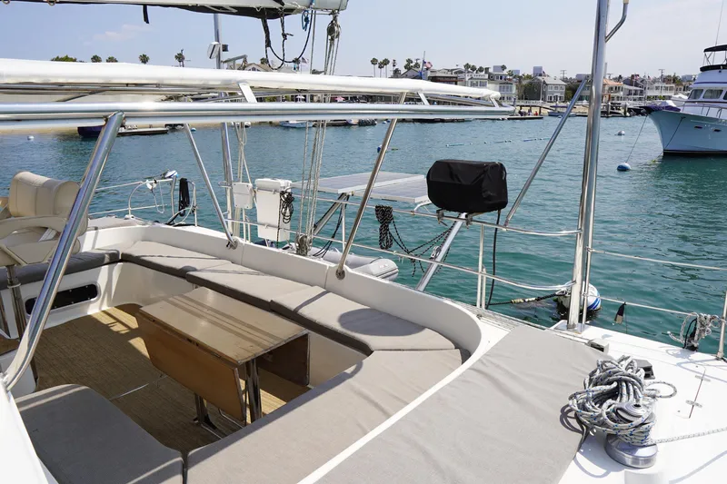 Loki Yacht Photos Pics Spacious deck of 1995 Fountaine Pajot Venezia 42 catamaran in a sunny marina.