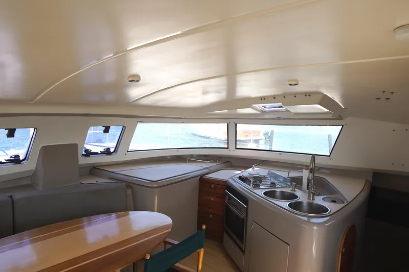 Loki Yacht Photos Pics Interior of 1995 Fountaine Pajot Venezia 42 catamaran with kitchen and dining area.