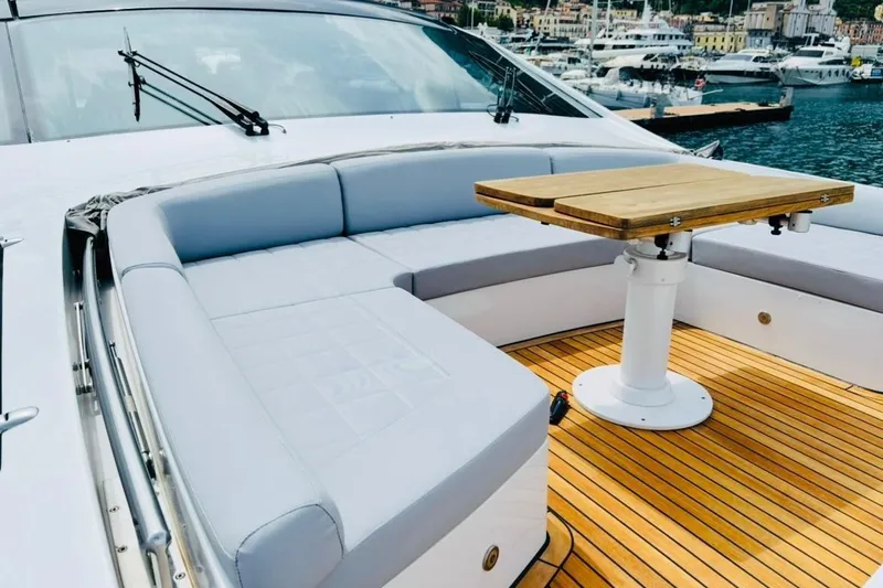  Yacht Photos Pics Luxurious 2009 Pershing 80' yacht with elegant deck seating and wooden table.