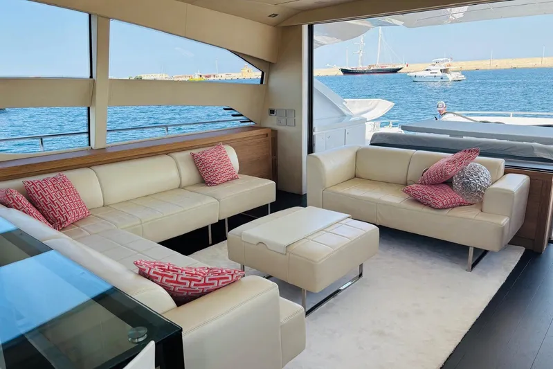  Yacht Photos Pics Luxurious interior of 2009 Pershing 80' yacht with cream sofas and red cushions.