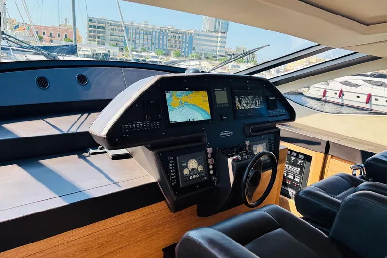  Yacht Photos Pics Helm of 2009 Pershing 80' yacht with navigation screens and leather seating.