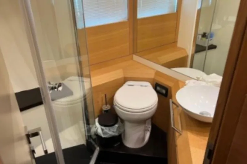  Yacht Photos Pics Luxurious bathroom on 2009 Pershing 80' yacht with modern fixtures and wooden accents.