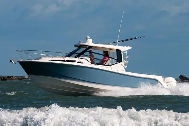  Yacht Photos Pics 2022 Boston Whaler 325 Conquest navigating through ocean waves.