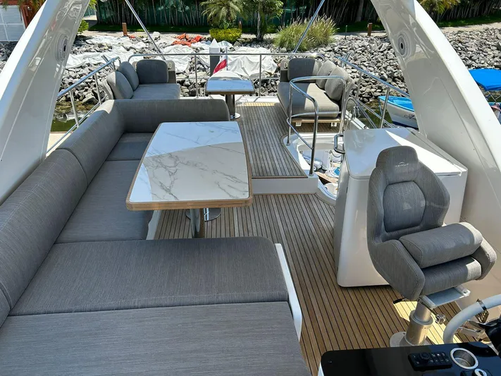 2021 Azimut 55 Fly @vallarta  Yacht Photos Pics Luxurious 2021 Azimut 55 yacht deck with elegant seating and marble tables.