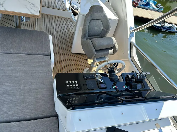 2021 Azimut 55 Fly @vallarta  Yacht Photos Pics Luxurious 2021 Azimut 55 yacht helm with modern controls and comfortable seating.