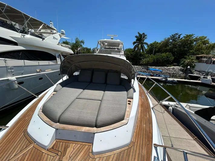 2021 Azimut 55 Fly @vallarta  Yacht Photos Pics Luxurious 2021 Azimut 55 yacht with sunbed, docked in a marina under clear blue sky.
