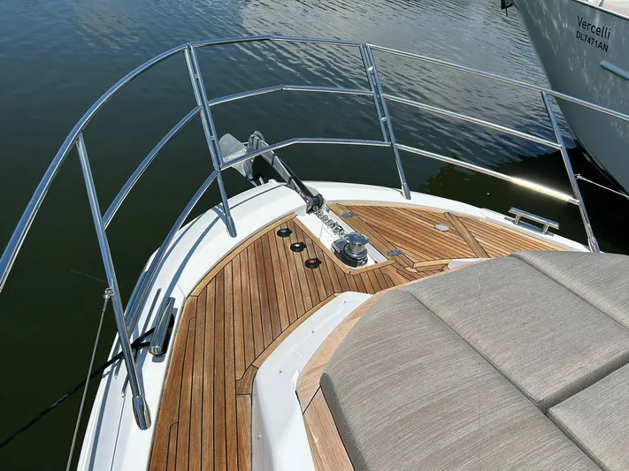 2021 Azimut 55 Fly @vallarta  Yacht Photos Pics Azimut 55 yacht bow with teak deck and cushioned seating, 2021 model.