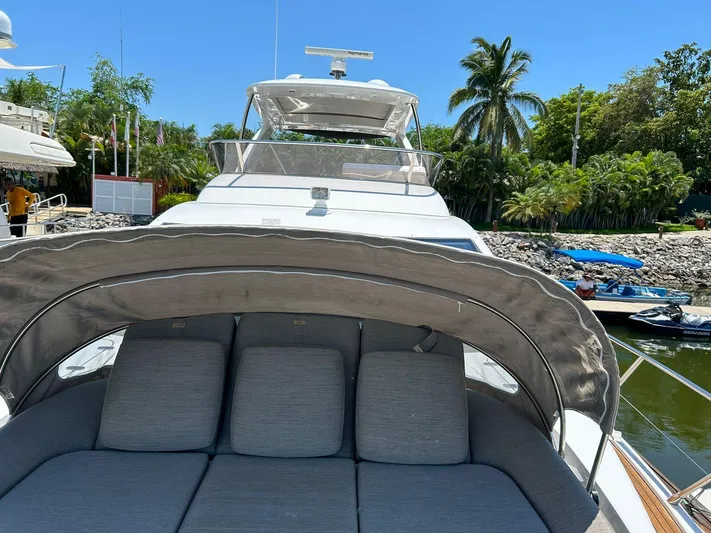 2021 Azimut 55 Fly @vallarta  Yacht Photos Pics Luxury Azimut 55 yacht, 2021 model, with sunbathing area and tropical marina backdrop.