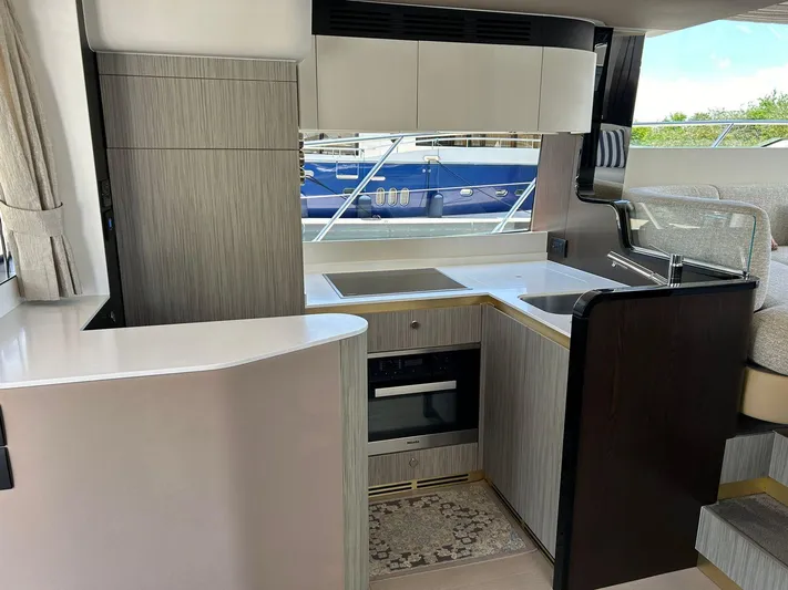 2021 Azimut 55 Fly @vallarta  Yacht Photos Pics Modern kitchen interior of 2021 Azimut 55 yacht with sleek cabinetry and appliances.