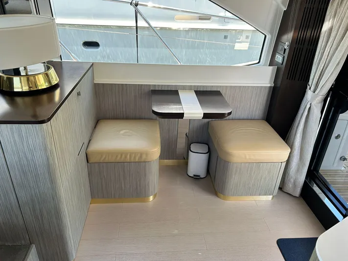2021 Azimut 55 Fly @vallarta  Yacht Photos Pics Luxurious interior of a 2021 Azimut 55 yacht with modern seating and table.
