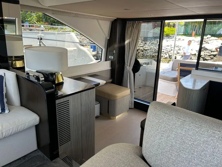 2021 Azimut 55 Fly @vallarta  Yacht Photos Pics Luxurious interior of a 2021 Azimut 55 yacht with modern furnishings and large windows.