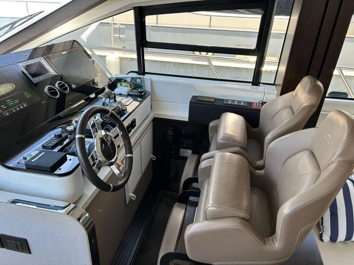 2021 Azimut 55 Fly @vallarta  Yacht Photos Pics Interior cockpit of a 2021 Azimut 55 yacht with modern controls and leather seating.