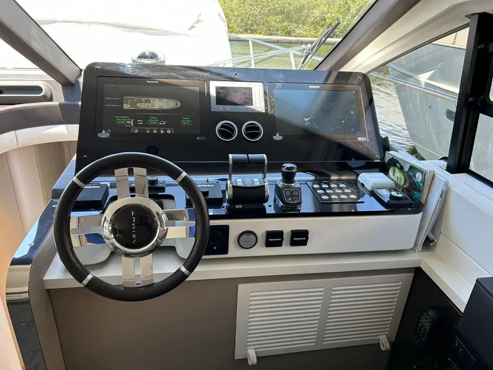 2021 Azimut 55 Fly @vallarta  Yacht Photos Pics Helm of 2021 Azimut 55 yacht with modern navigation controls and steering wheel.