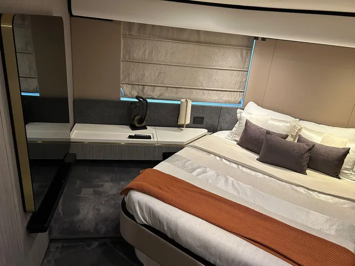 2021 Azimut 55 Fly @vallarta  Yacht Photos Pics Luxurious bedroom interior of 2021 Azimut 55 yacht with modern decor and cozy bedding.
