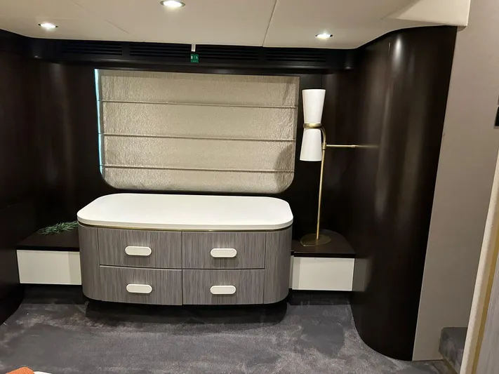2021 Azimut 55 Fly @vallarta  Yacht Photos Pics Luxurious interior of 2021 Azimut 55 yacht with modern dresser and elegant lamp.