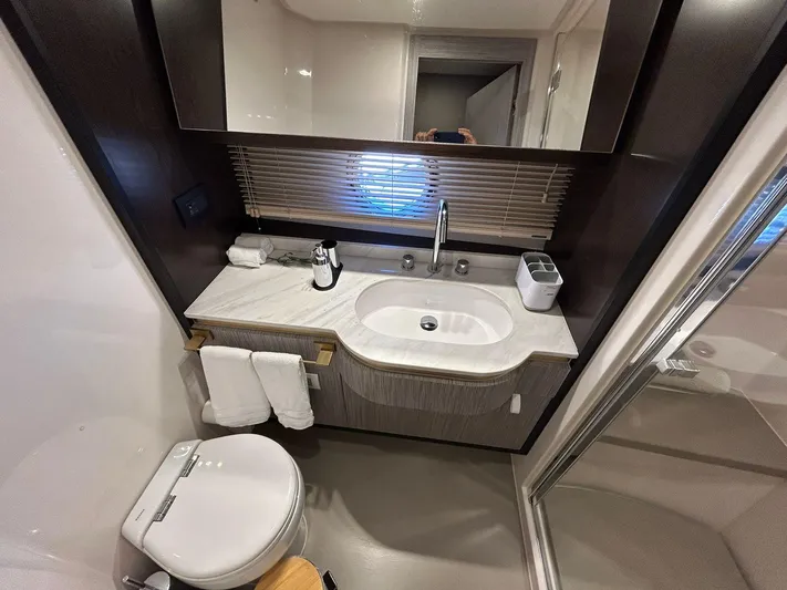 2021 Azimut 55 Fly @vallarta  Yacht Photos Pics Luxury bathroom in 2021 Azimut 55 yacht with modern fixtures and elegant design.