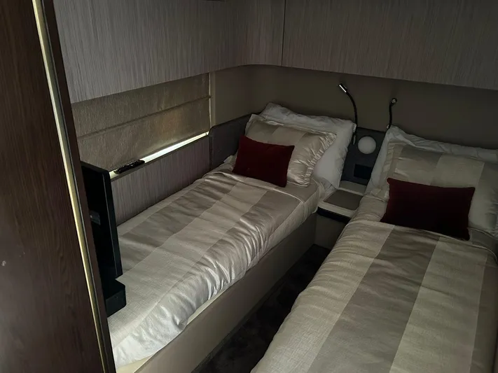 2021 Azimut 55 Fly @vallarta  Yacht Photos Pics Luxurious twin cabin in 2021 Azimut 55 yacht with modern decor and plush bedding.