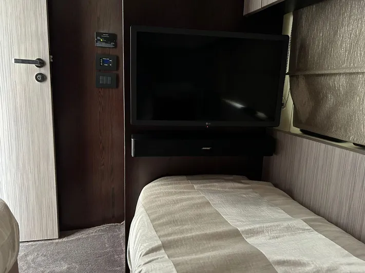 2021 Azimut 55 Fly @vallarta  Yacht Photos Pics Interior of 2021 Azimut 55 yacht with TV and cozy bed setup.