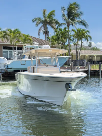  Yacht Photos Pics 2010 Grady-White Canyon 336 boat on water, surrounded by palm trees and waterfront homes.