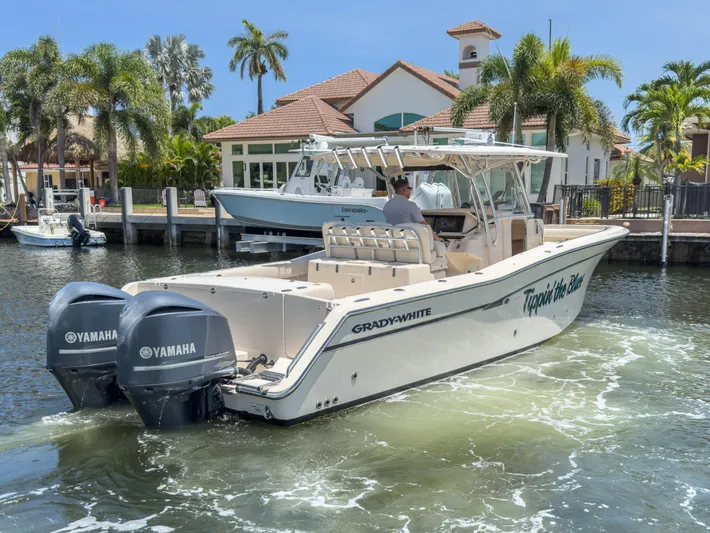  Yacht Photos Pics 2010 Grady-White Canyon 336 boat with Yamaha engines on a sunny waterfront.