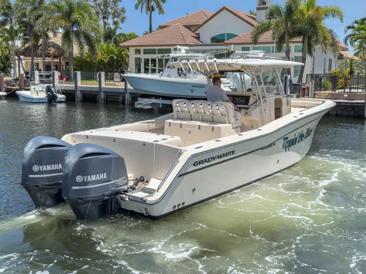  Yacht Photos Pics 2010 Grady-White Canyon 336 boat with Yamaha engines on a sunny waterfront.