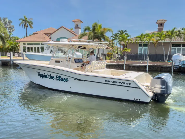  Yacht Photos Pics 2010 Grady-White Canyon 336 boat on water near a dock, sunny day.