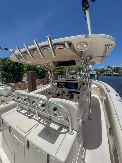  Yacht Photos Pics 2010 Grady-White Canyon 336 boat interior with helm, rod holders, and seating.