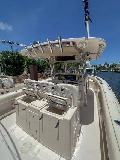  Yacht Photos Pics 2010 Grady-White Canyon 336 boat interior with helm and seating, docked by a canal.